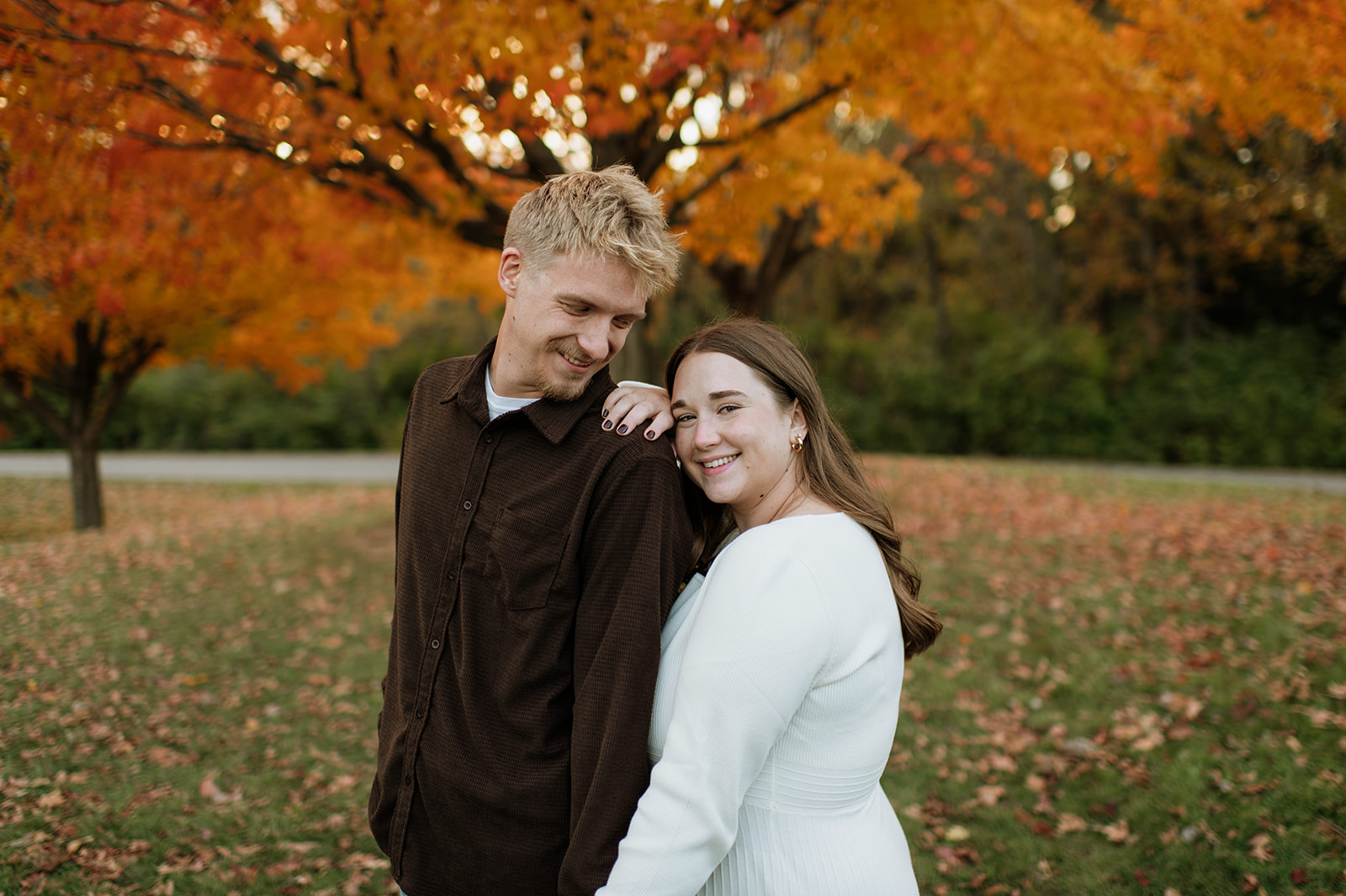 Couple posing at St Pat's Park for their South Bend engagement photos in the fall.