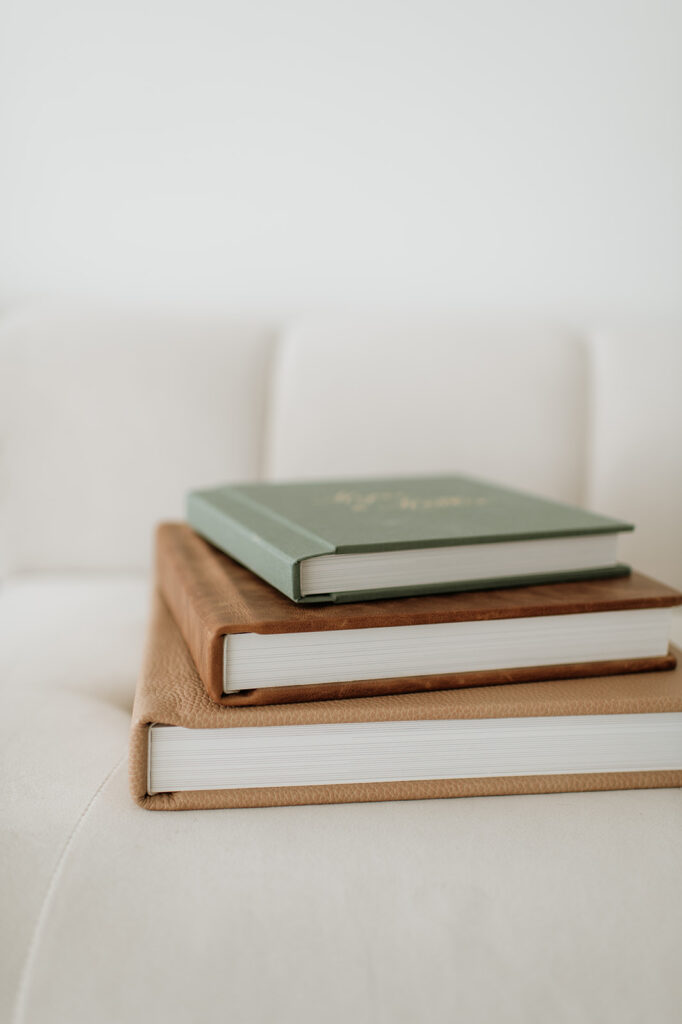 Wedding albums stacked on top of one another.