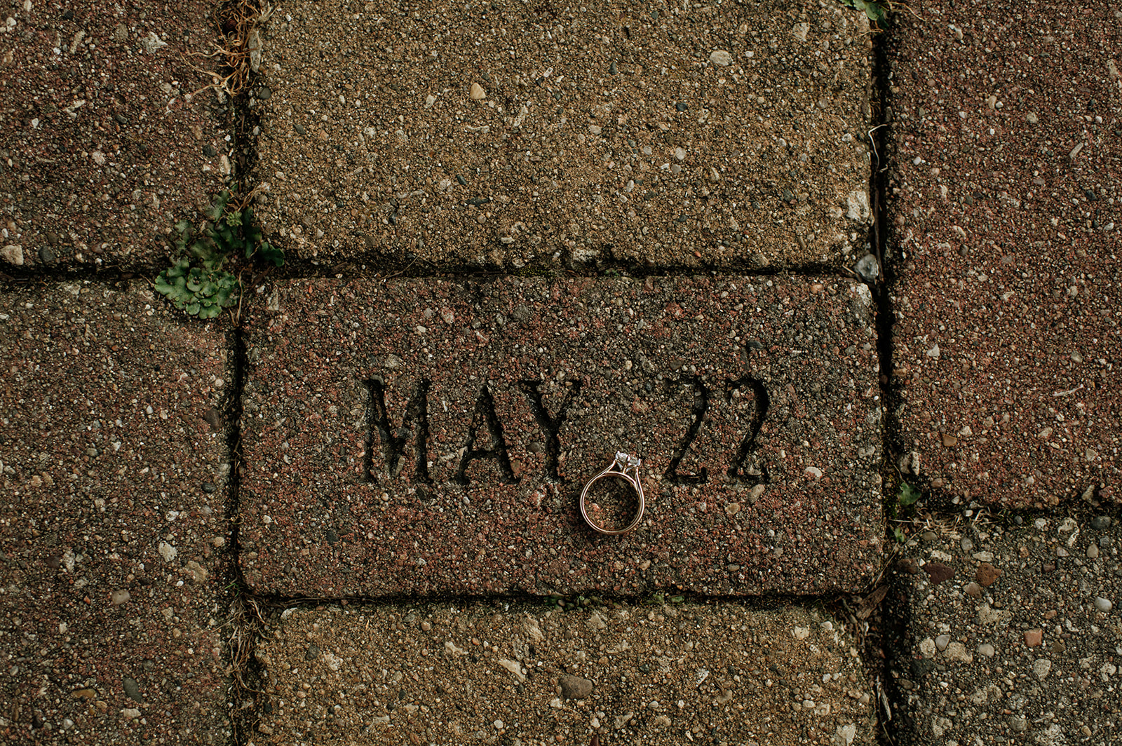 May 22nd on a brick with an engagement ring to showcase the engagement date. 