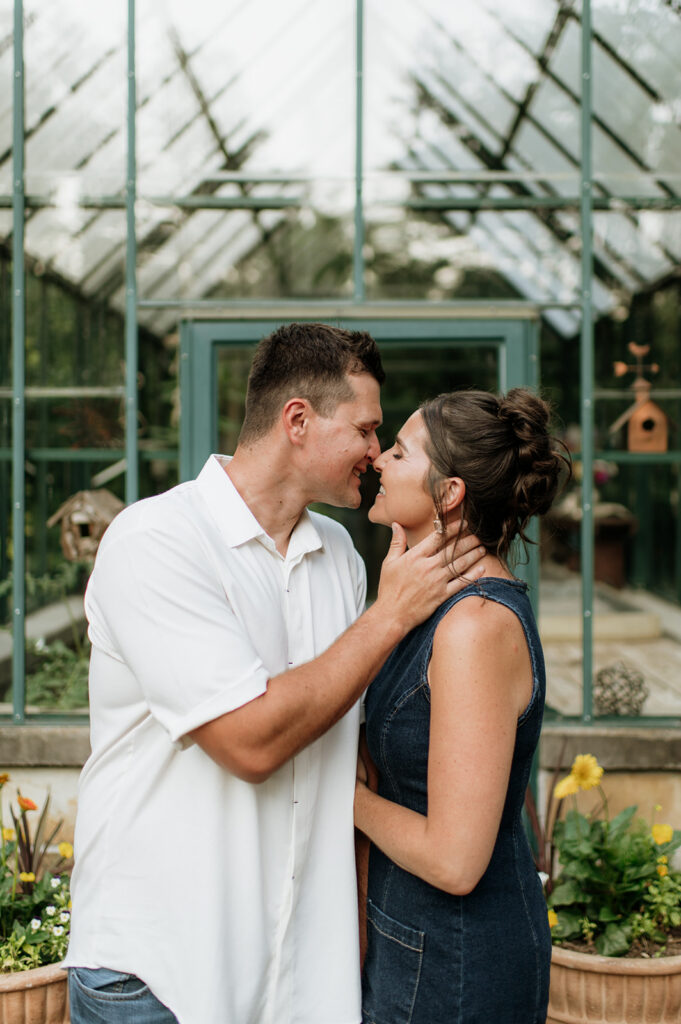 Close up shot of a couple posing in front of a pavilion at Defries Gardens in New Paris, Indiana for their engagement photos.