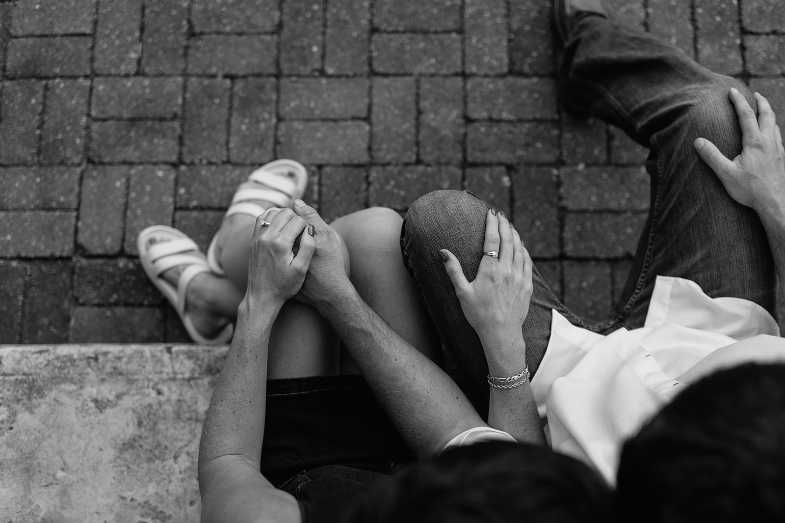 Black and white overhead photo of a couple sitting together.