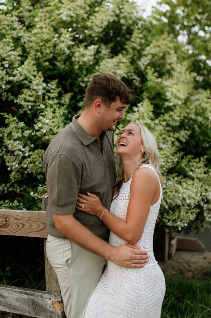 Candid photo of a couple laughing during their outdoor engagement photos.
