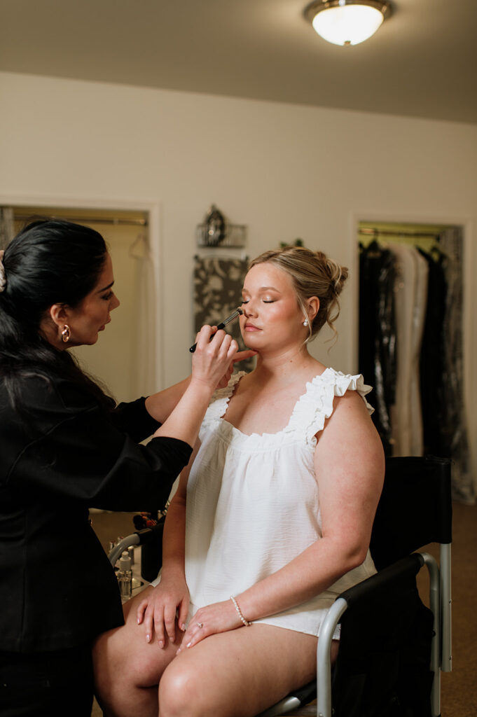 Bride getting her makeup done for her wedding day.