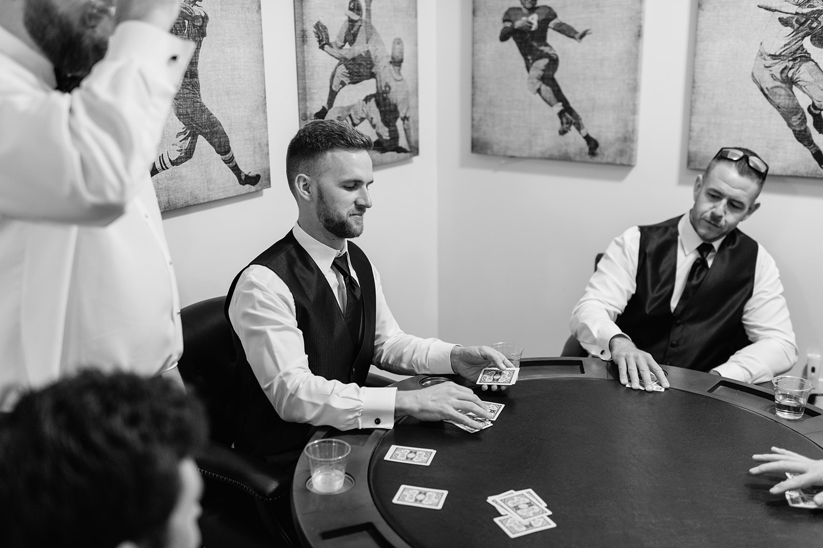 Black and white photo of the groomsmen playing poker inside the Grooms Lounge at The Morris Estate in Niles, Michigan.