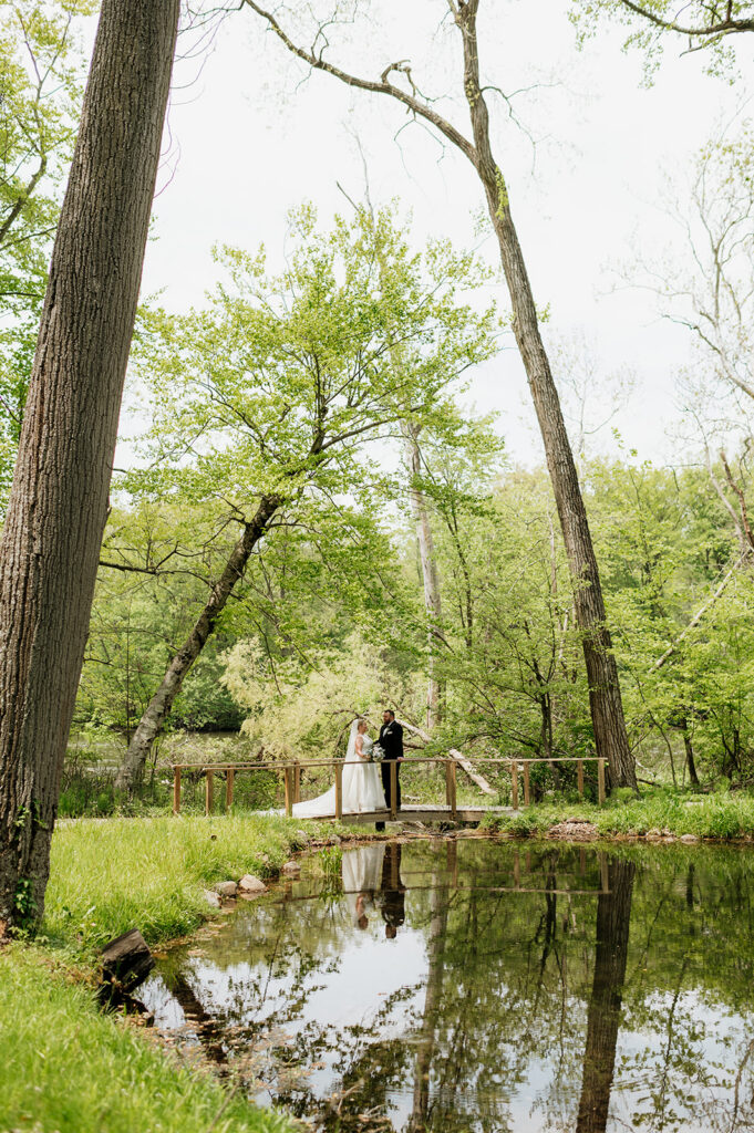 Bride and groom standing on the bridge at The Morris Estate in Niles, Michigan.