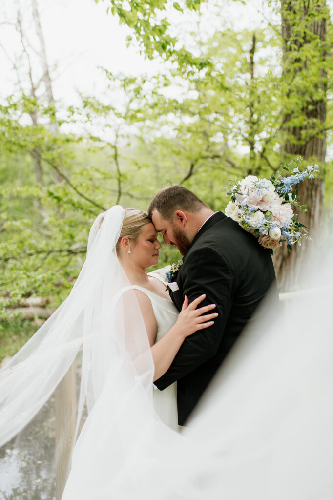 Bride and groom posing forehead to forehead for their wedding at The Morris Estate in Niles, Michigan.
