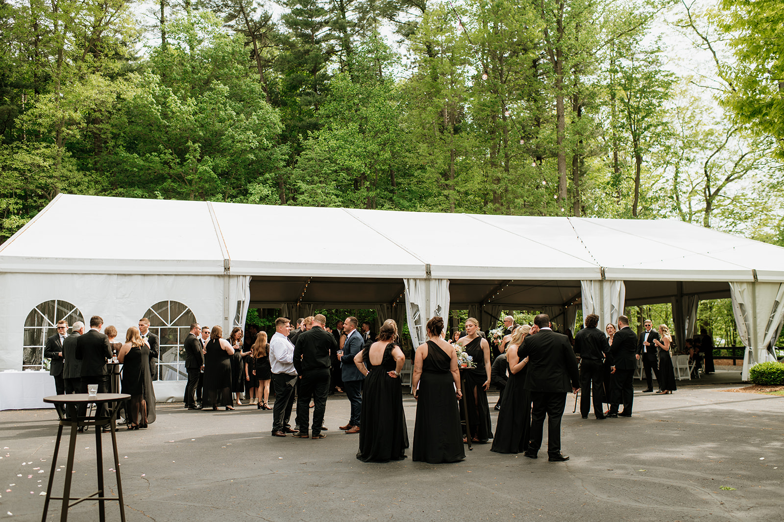 Guests mingling during cocktail hour outside of the tented wedding reception area at The Morris Estate.
