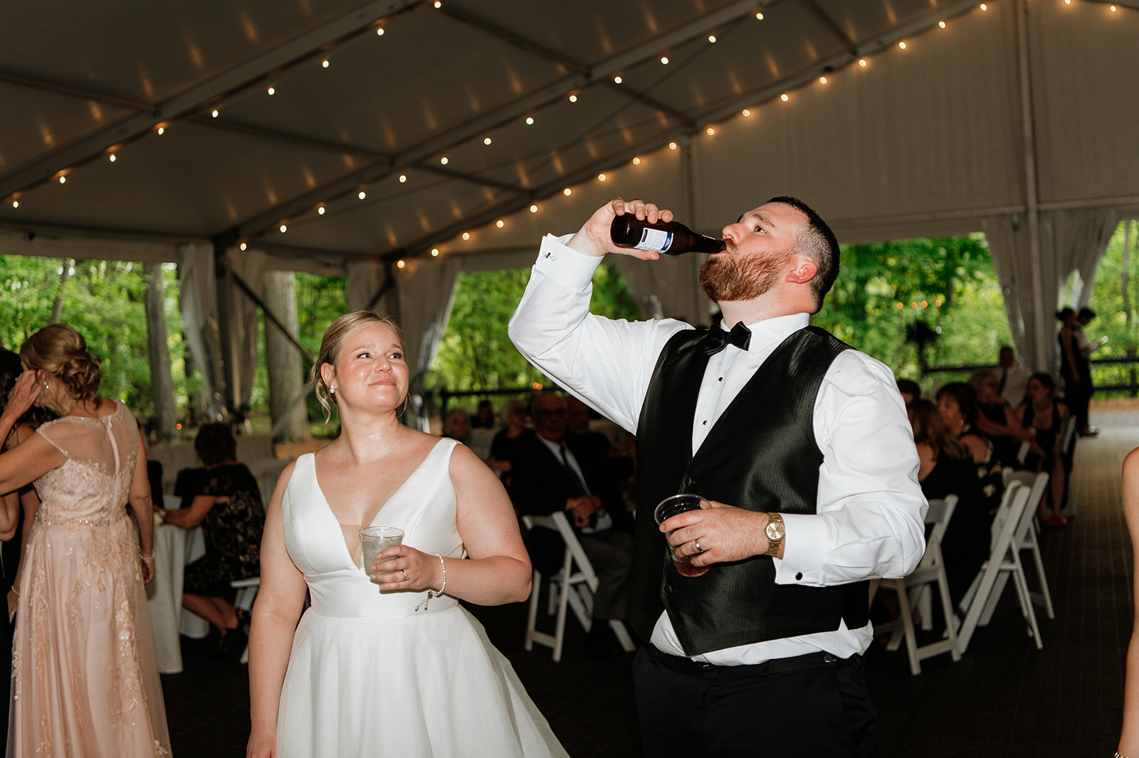 Bride and groom having drinks during their Morris Estate wedding reception.