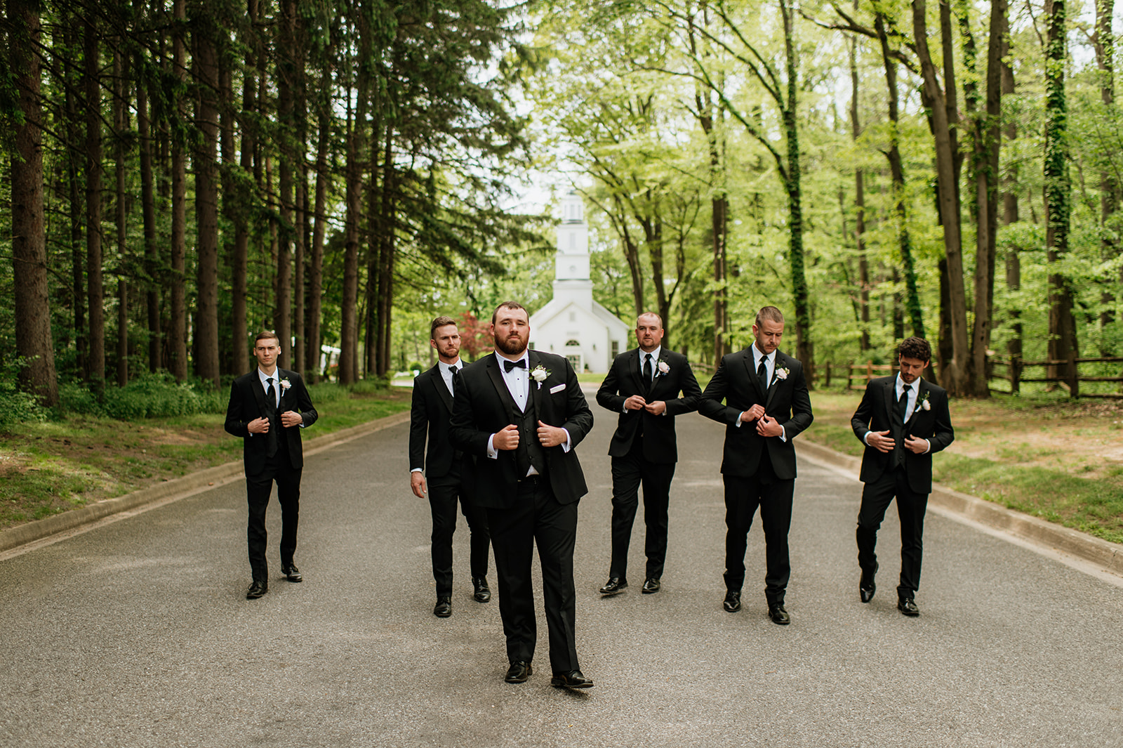 Outdoor groom and groomsmen photos in front of the chapel at The Morris Estate in Niles, Michigan.