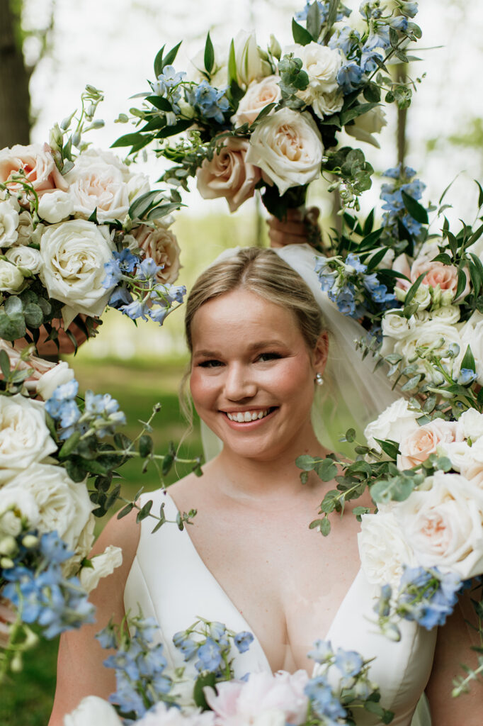 Bride posing with bouquets surrounding her for her portraits.